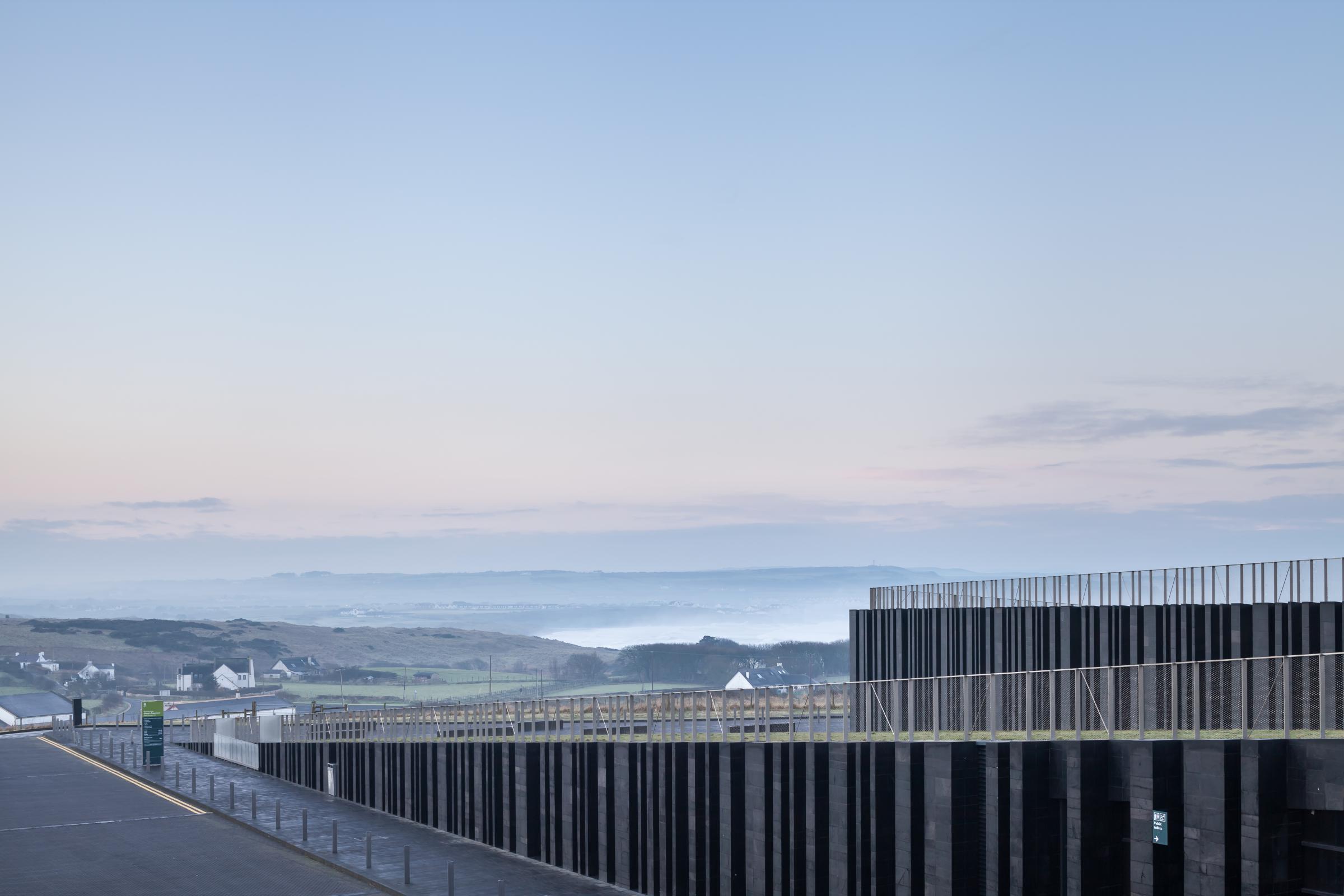 Photograph of Giants Causway Visitor Centre, designed by Heneghan Peng Architects and located in Bushmills, United Kingdom