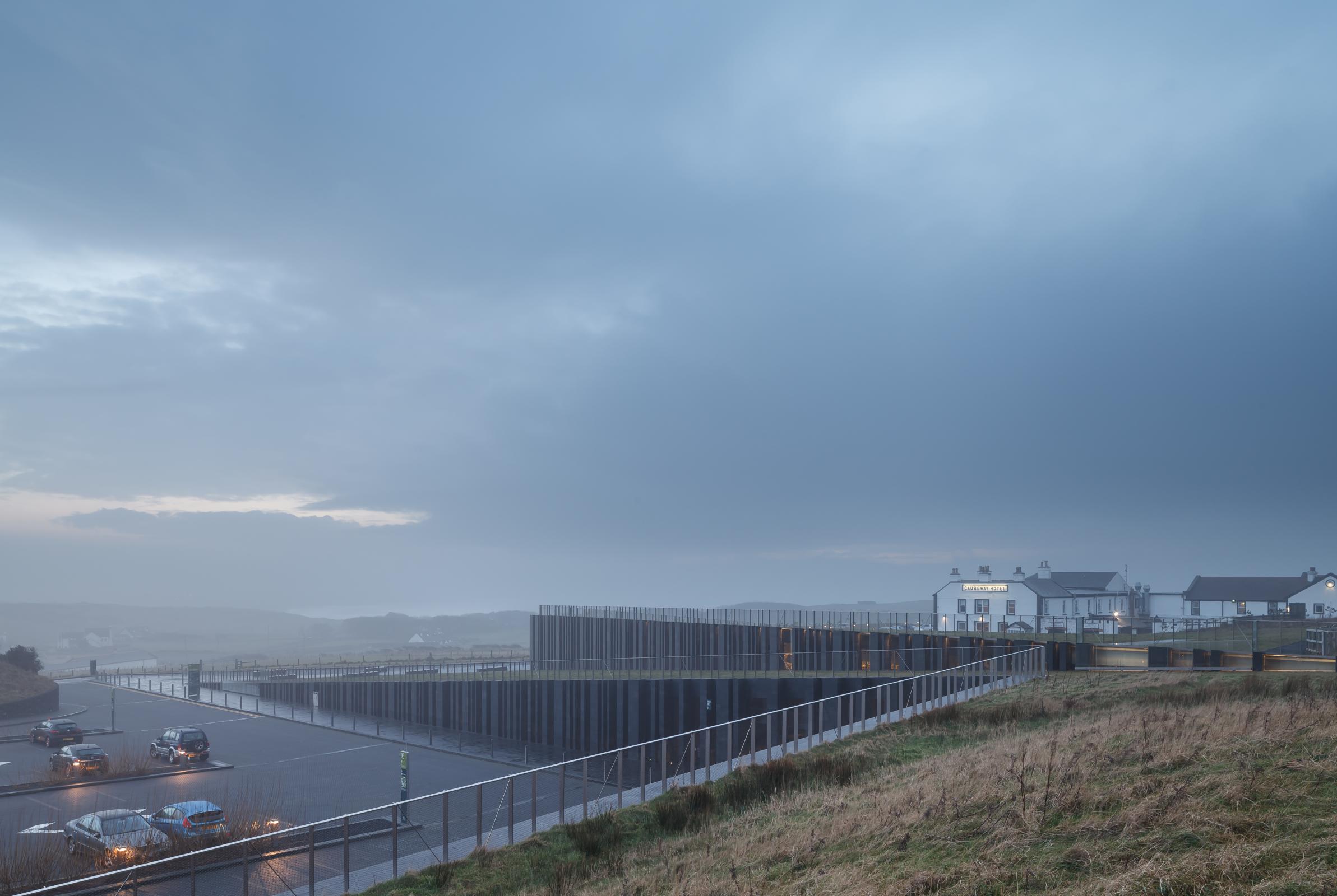 Photograph of Giants Causway Visitor Centre, designed by Heneghan Peng Architects and located in Bushmills, United Kingdom