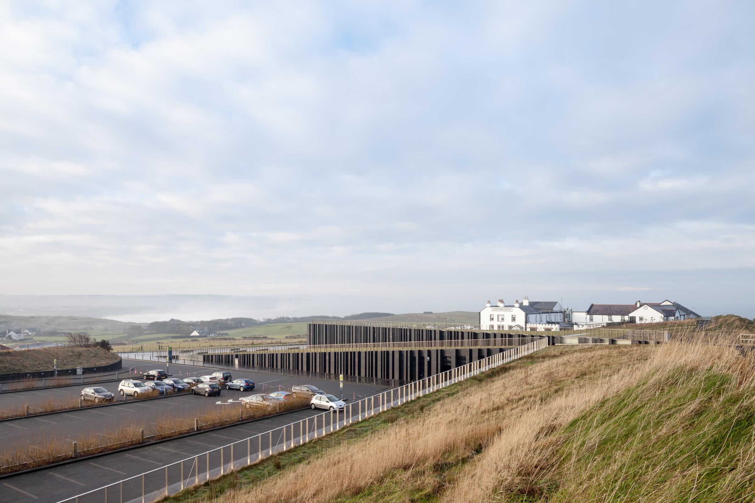 Photograph of Giants Causway Visitor Centre, designed by Heneghan Peng Architects and located in Bushmills, United Kingdom