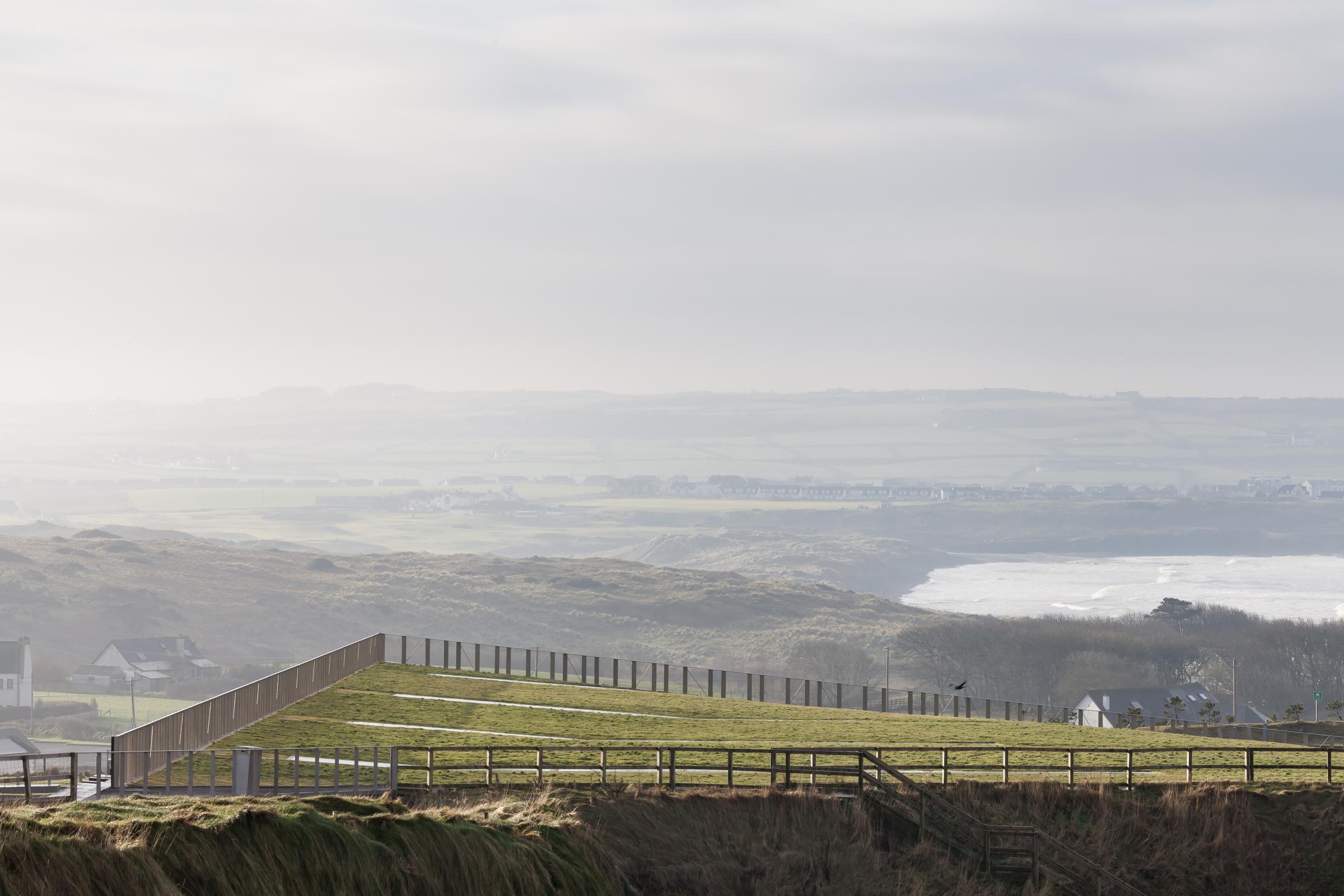 Photograph of Giants Causway Visitor Centre, designed by Heneghan Peng Architects and located in Bushmills, United Kingdom