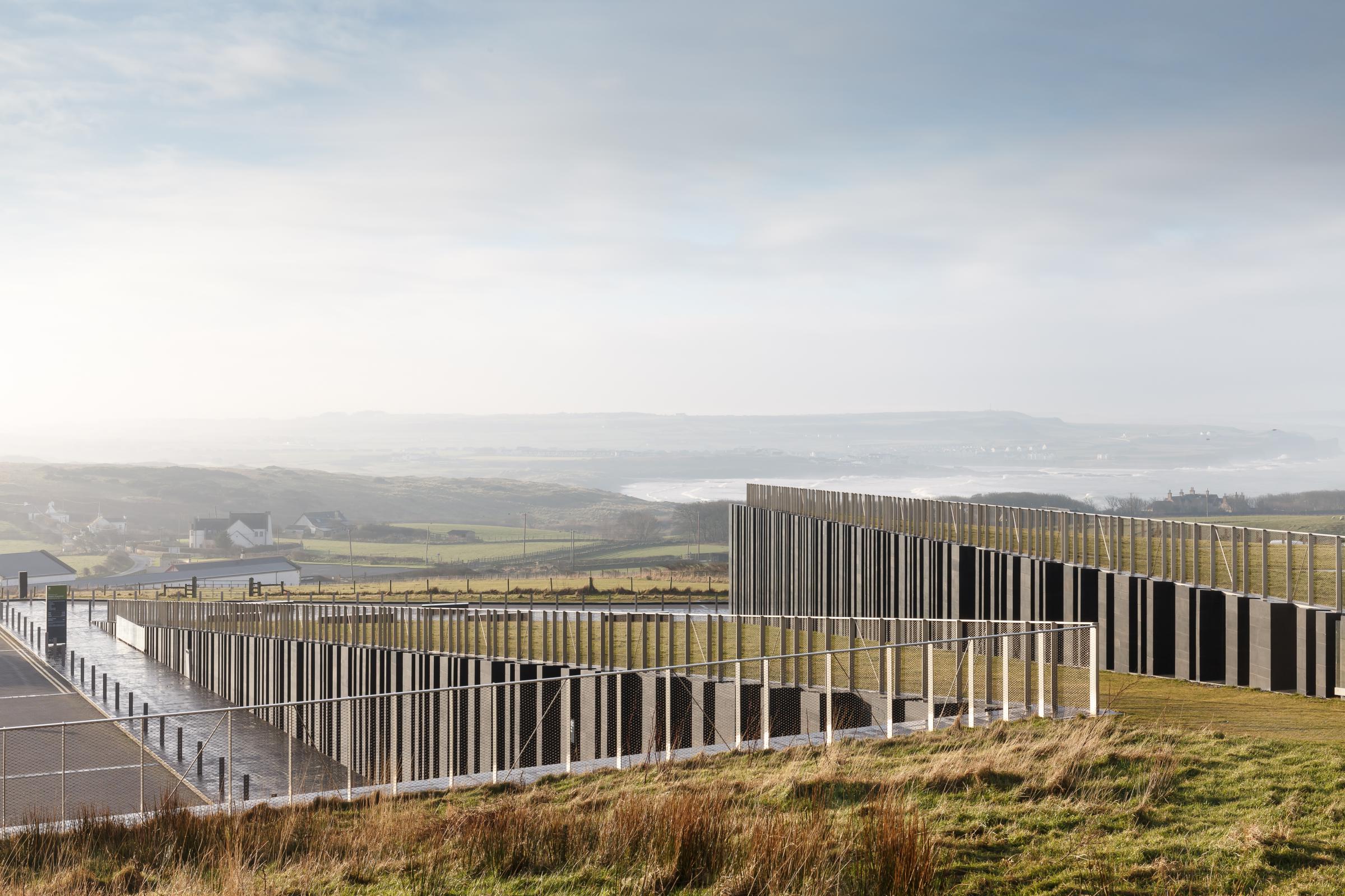 Photograph of Giants Causway Visitor Centre, designed by Heneghan Peng Architects and located in Bushmills, United Kingdom