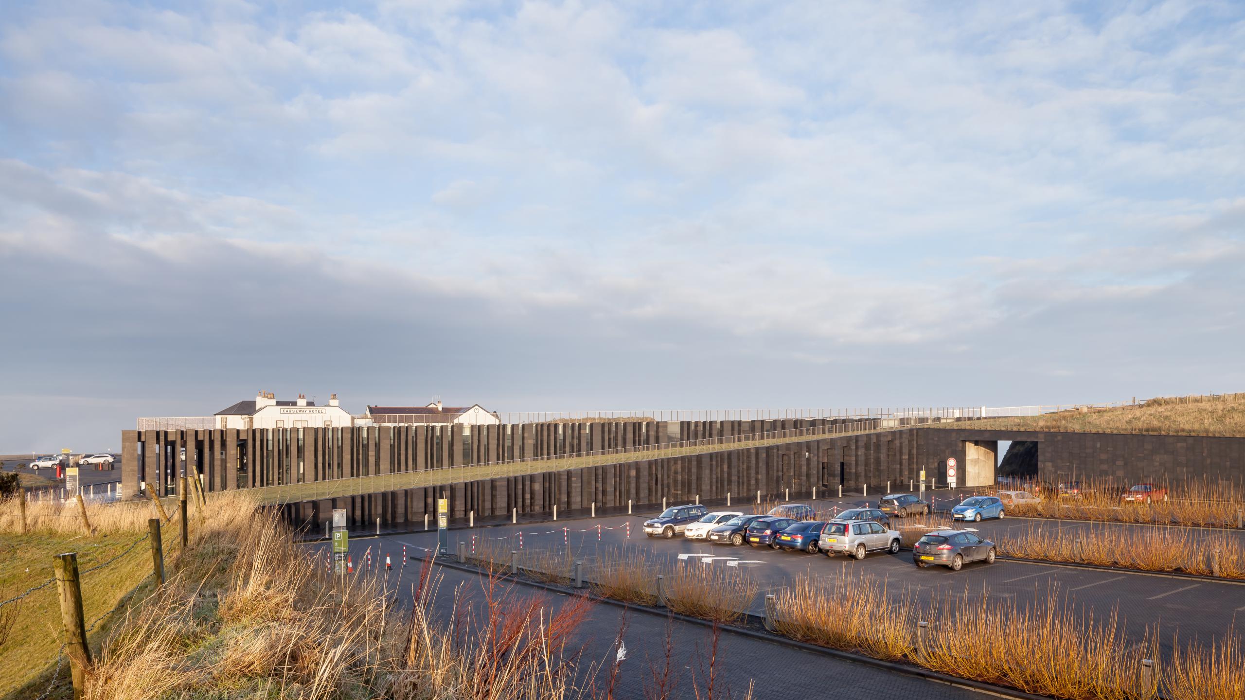 Photograph of Giants Causway Visitor Centre, designed by Heneghan Peng Architects and located in Bushmills, United Kingdom