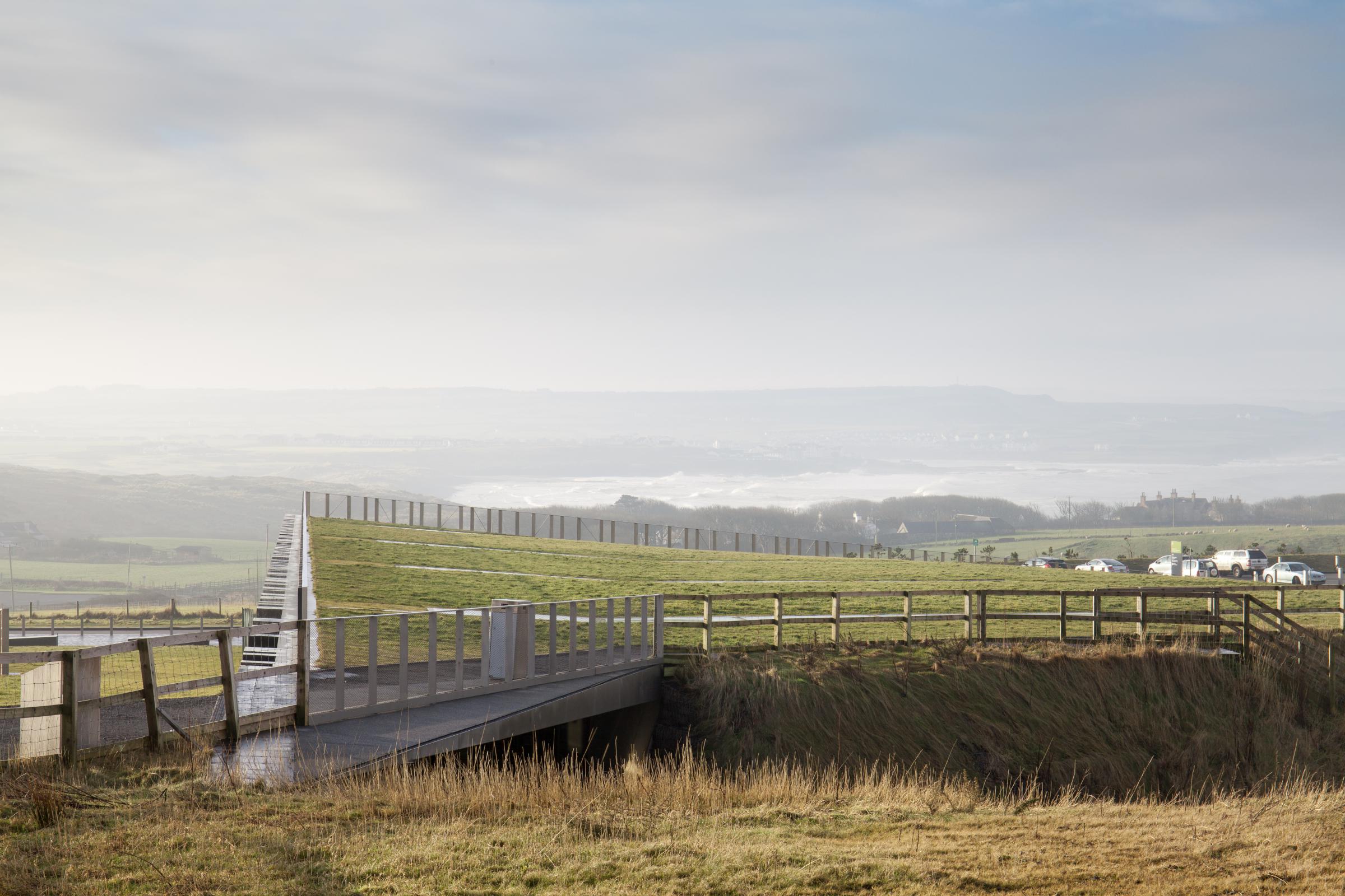 Photograph of Giants Causway Visitor Centre, designed by Heneghan Peng Architects and located in Bushmills, United Kingdom