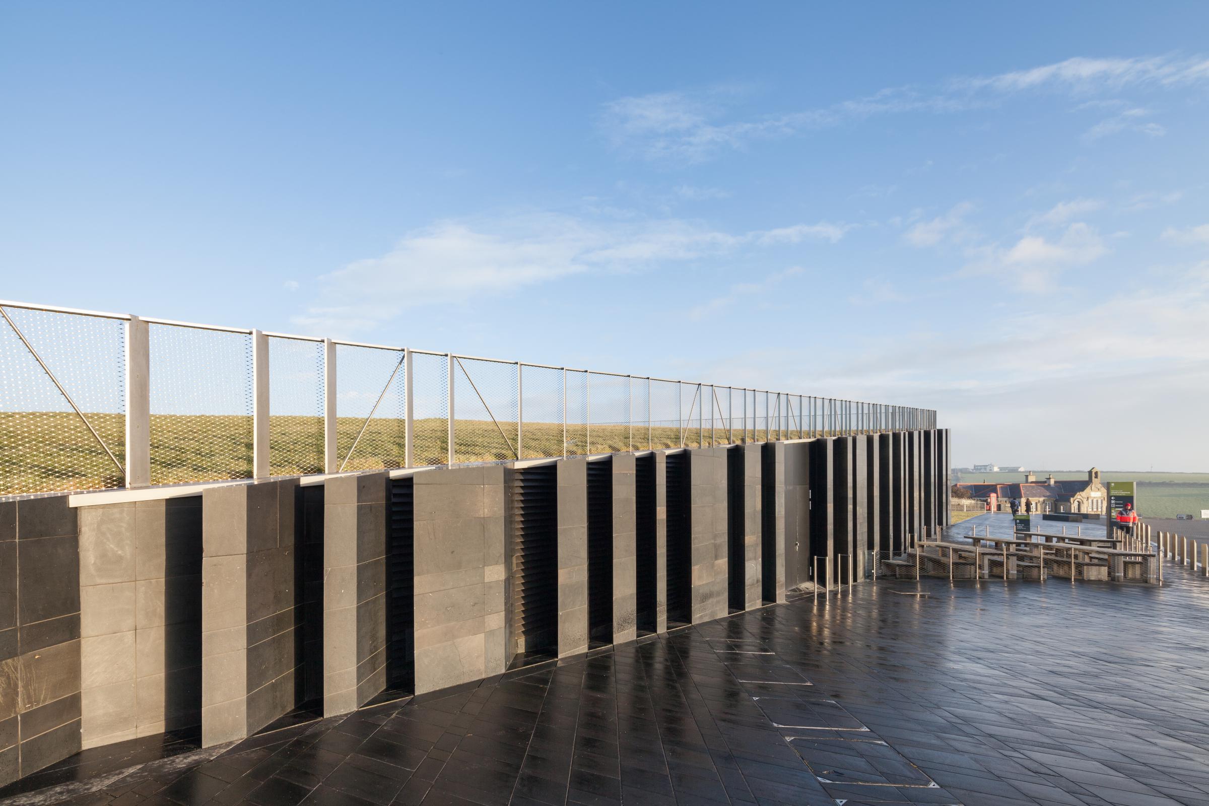 Photograph of Giants Causway Visitor Centre, designed by Heneghan Peng Architects and located in Bushmills, United Kingdom