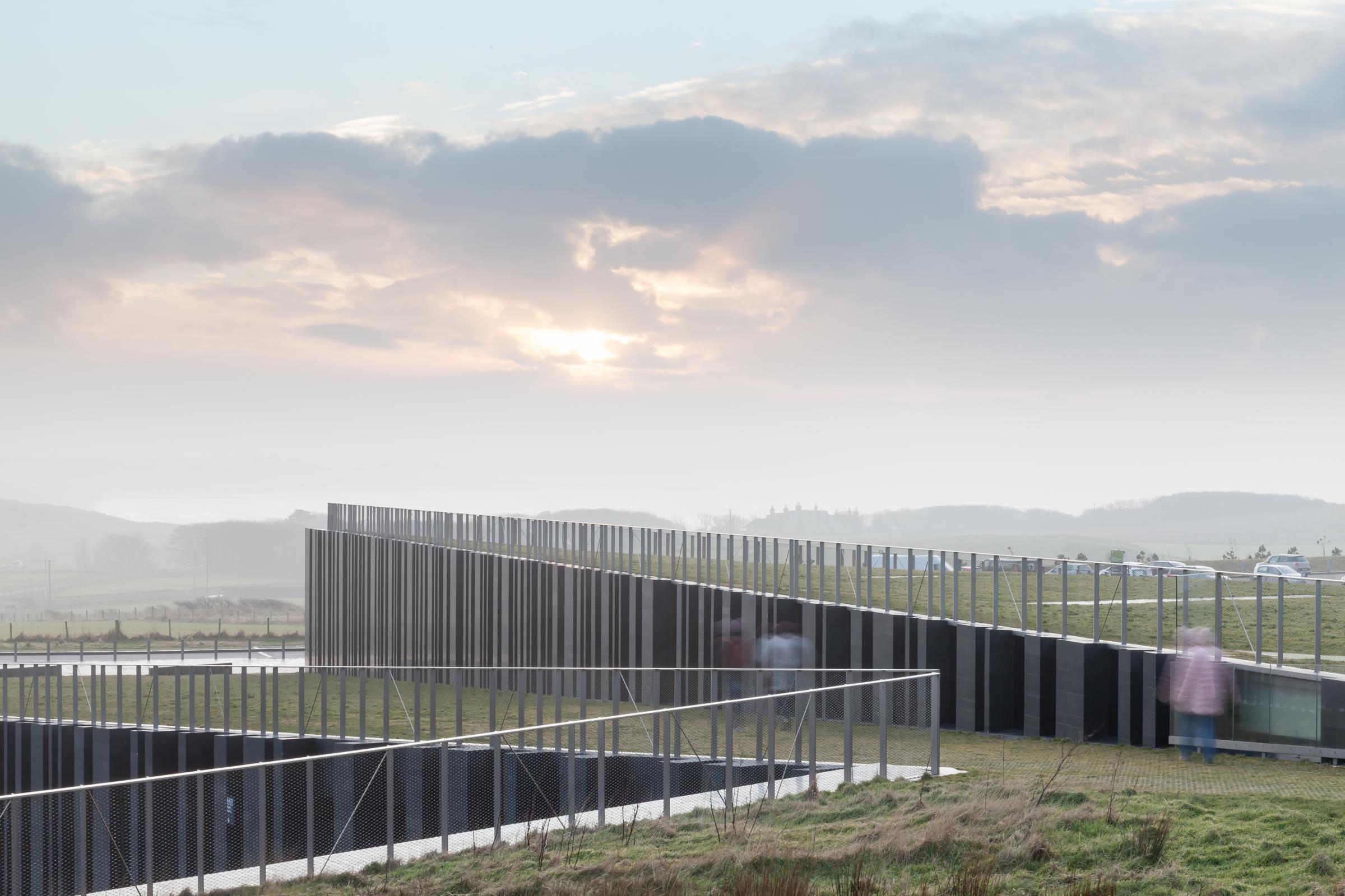 Photograph of Giants Causway Visitor Centre, designed by Heneghan Peng Architects and located in Bushmills, United Kingdom