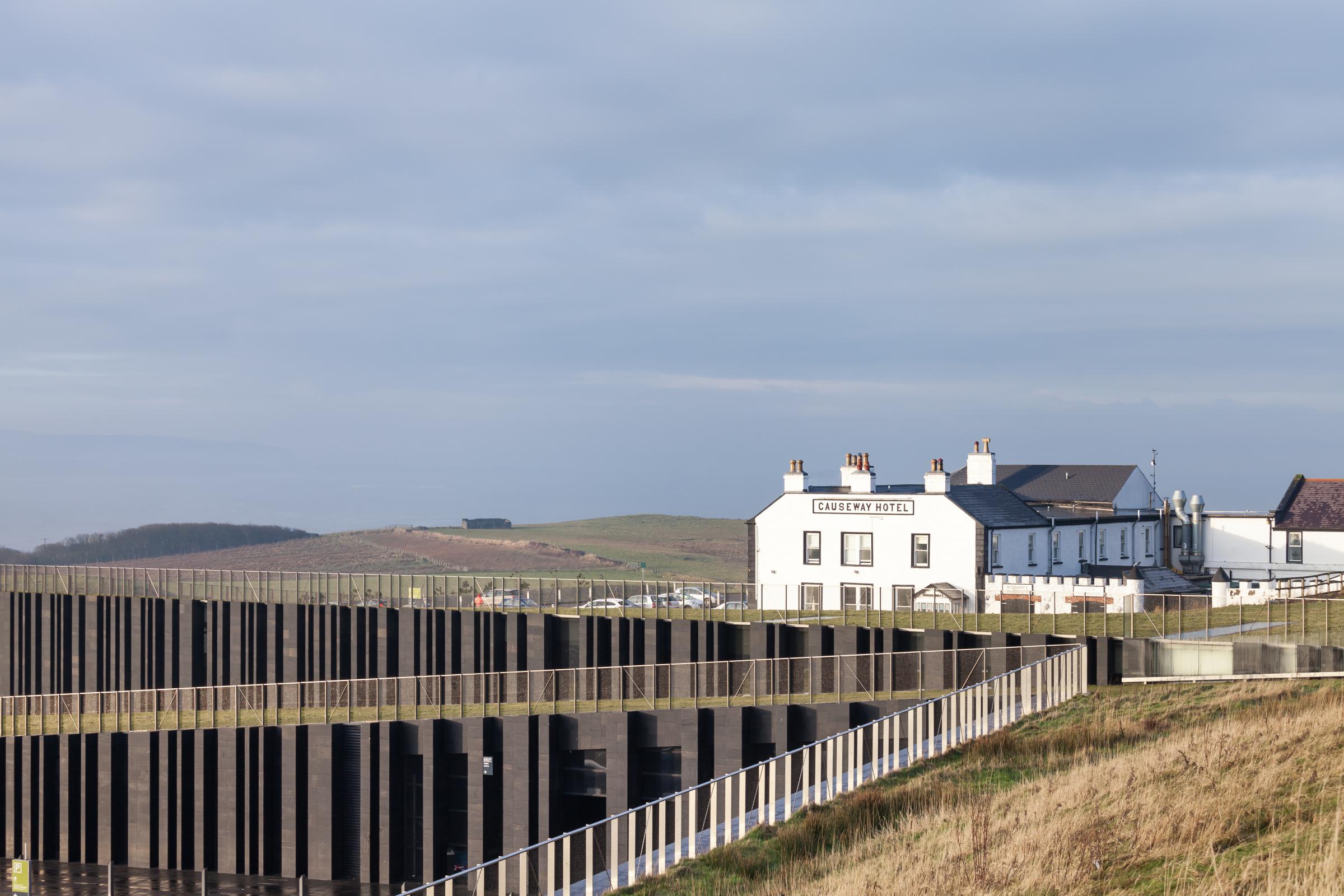 Photograph of Giants Causway Visitor Centre, designed by Heneghan Peng Architects and located in Bushmills, United Kingdom