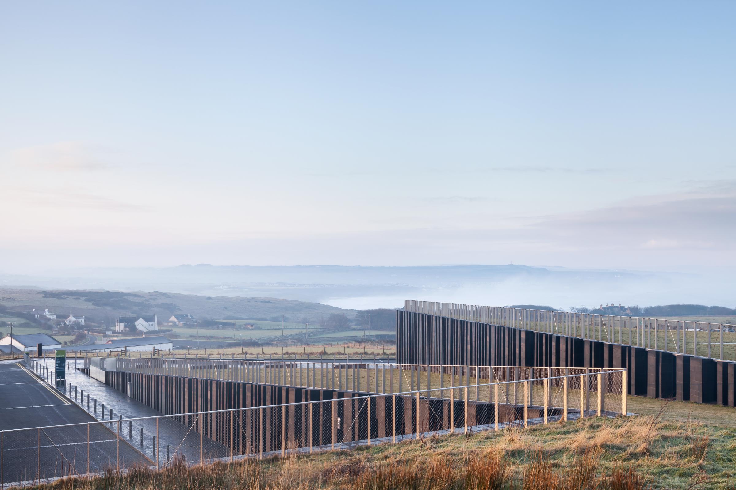 Photograph of Giants Causway Visitor Centre, designed by Heneghan Peng Architects and located in Bushmills, United Kingdom