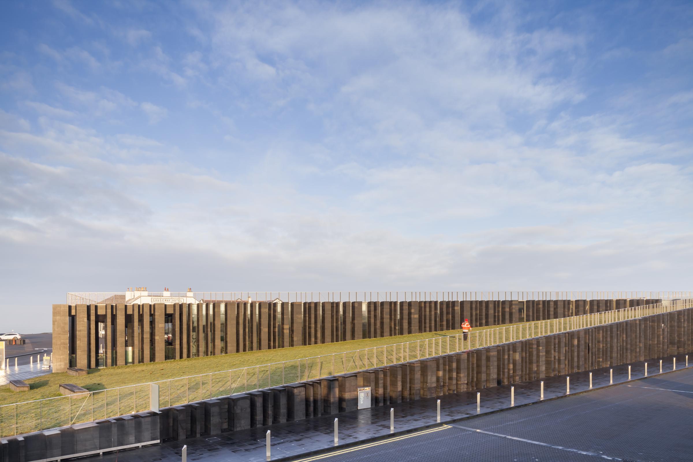 Photograph of Giants Causway Visitor Centre, designed by Heneghan Peng Architects and located in Bushmills, United Kingdom