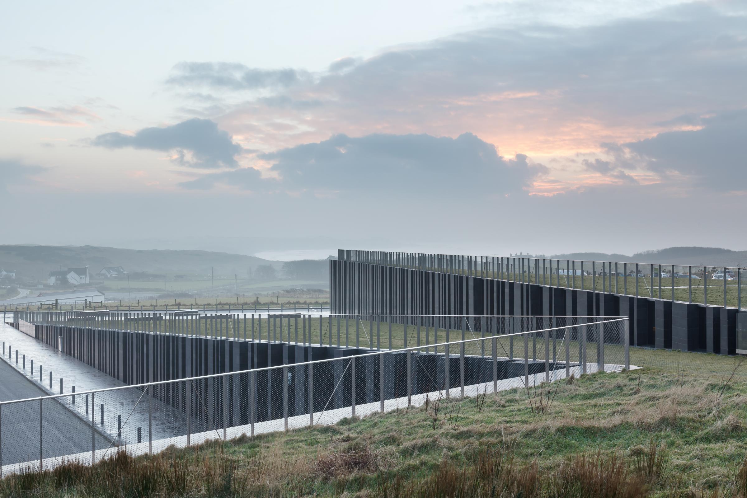 Photograph of Giants Causway Visitor Centre, designed by Heneghan Peng Architects and located in Bushmills, United Kingdom