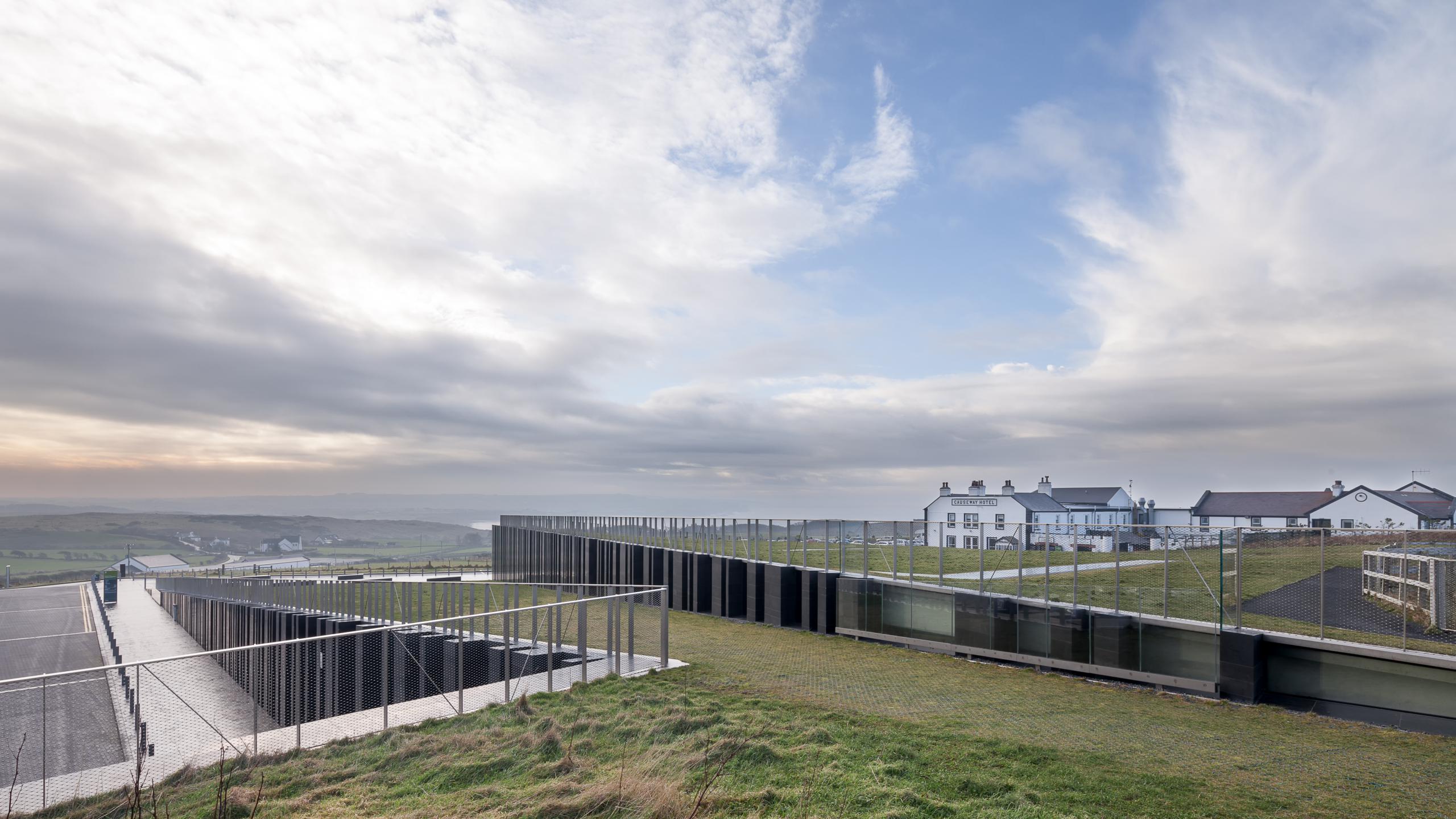 Photograph of Giants Causway Visitor Centre, designed by Heneghan Peng Architects and located in Bushmills, United Kingdom