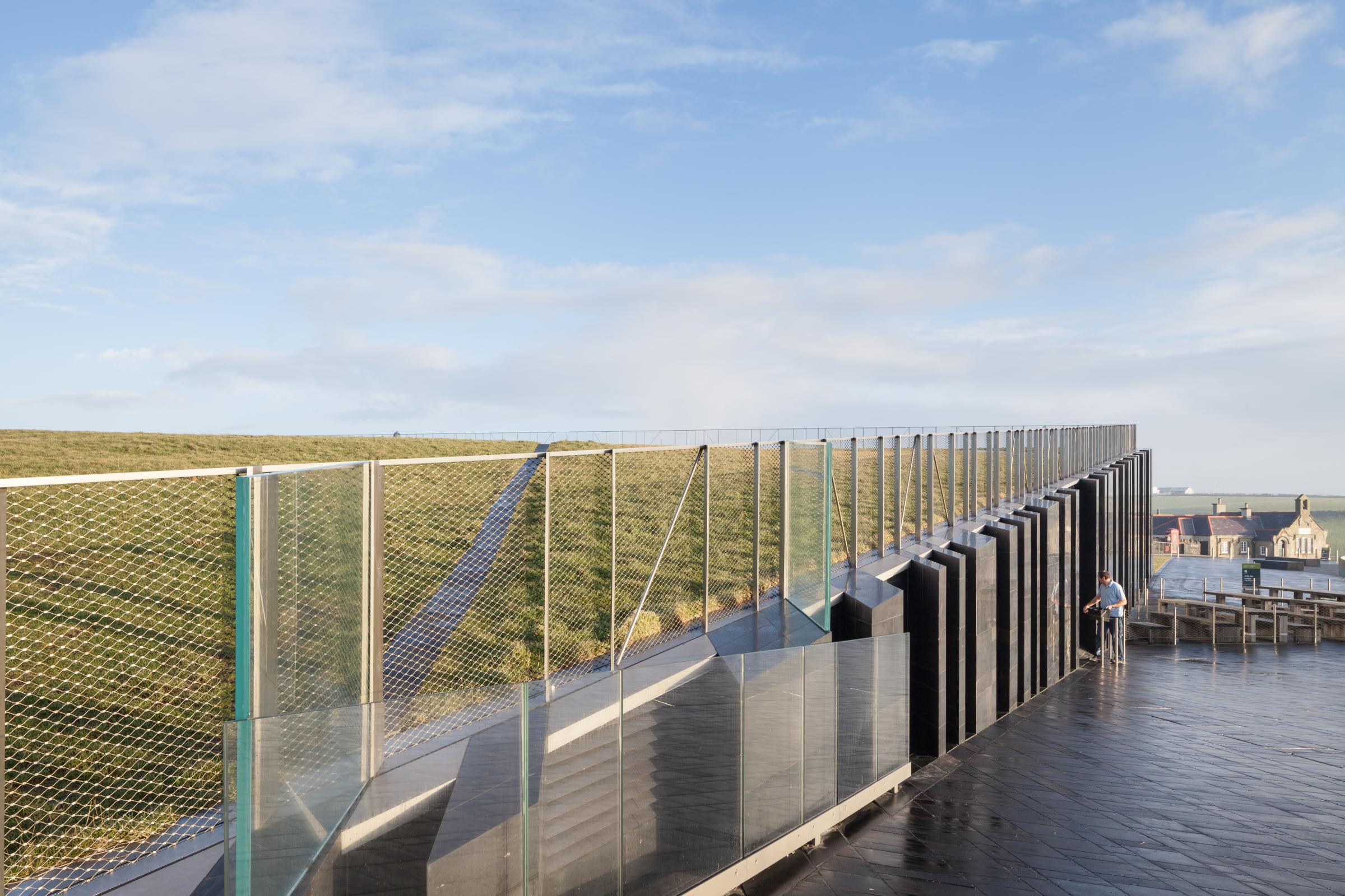 Photograph of Giants Causway Visitor Centre, designed by Heneghan Peng Architects and located in Bushmills, United Kingdom